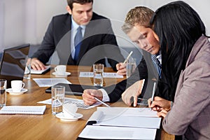 Team of 3 business people working on calculations photo