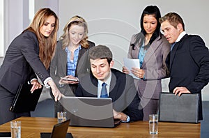 Team of 5 business people during meeting