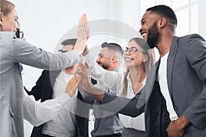 Team achievement, diverse business people giving high five