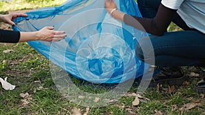 Team of activists collecting rubbish and plastic waste to recycle