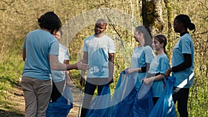 Team of activists picking up plastic waste to recycle and collect rubbish