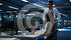 Team of admins in data center ensuring system can handle networking tasks