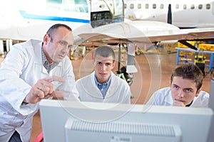 Team aircraft engineers repairing parts jet