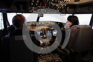 Team of airliner and captain using power switch on cabin dashboard