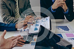 A team of analysts works on a financial data analysis dashboard on paper to use as market indicators