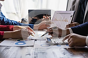 A team of analysts works on a financial data analysis dashboard on paper to use as market indicators