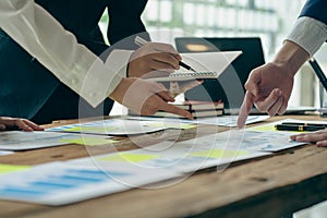 A team of analysts works on a financial data analysis dashboard on paper to use as market indicators