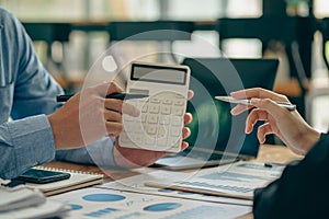 A team of analysts works on a financial data analysis dashboard on paper to use as market indicators