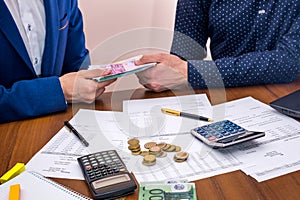 team analyzes the business expenses of the annual budget, counting euros.