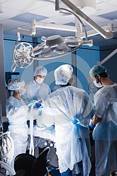 Team of anesthetists preparing patient for surgery at the operating room