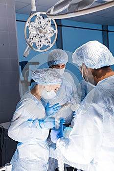 Team of anesthetists preparing patient for surgery at the operating room