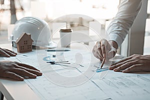 Team architect or engineering people discussion working on table together at a construction site