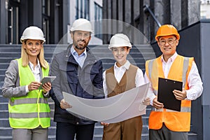 Team of architects builders, diverse group of men and women, inspecting construction stages of office building from