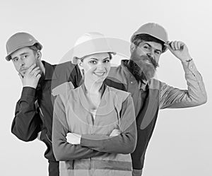 Team of architects, builders, labourers peeking behind leader isolated white background. Female leader concept. Woman