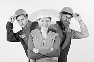 Team of architects, builders, labourers peeking behind leader isolated white background. Team and leadership concept