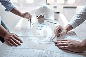 Team of architects or engineering consulting and analyzing working on objects tools and construction drawings inspection,
