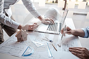 Team of architects or engineering consulting and analyzing working on objects tools and construction drawings inspection,