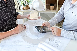 Team of architects or engineering consulting and analyzing working on objects tools and construction drawings inspection,