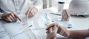 Team of architects or engineering consulting and analyzing working on objects tools and construction drawings inspection,