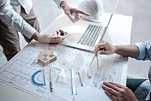 Team of architects or engineering consulting and analyzing working on objects tools and construction drawings inspection,