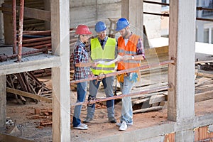 Team of architects looking plan at site