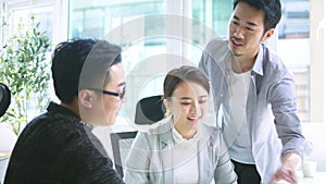 Team of asian business people working together in office