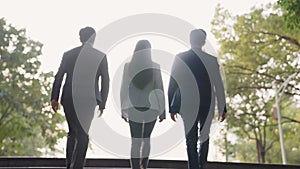 Team of asian businesspeople ascending stairs