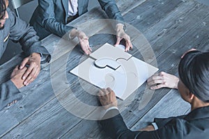 Team assembling jigsaw puzzle