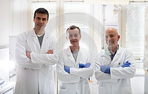 Team of biologists in white coats in laboratory