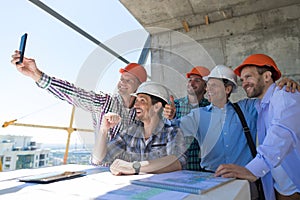 Team Of Builders Happy Smiling Take Selfie Photo During Meeting With Architect And Engineer On Construction Site