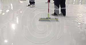 A team of builders makes heavy Duty Industrial Floor Coatings. A team of professionals makes a polymer floor in a