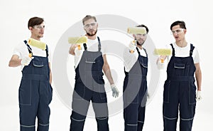 Team of builders with paint rollers