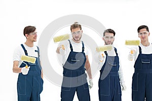 Team of builders with paint rollers