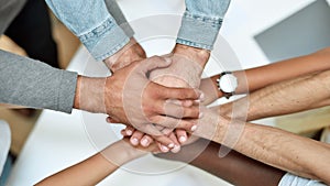 Team building. Multiracial group of people holding hands together