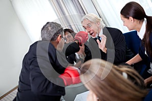 Team of business associates fighting in the office photo