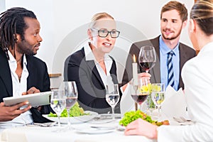 Team at business lunch meeting in restaurant