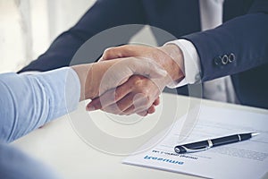 Team Business Partners shaking hands together to Greeting Start up new project. Shakehand Teamwork Partnership at office desk.