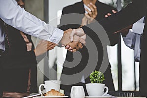 Team Business Partners shaking hands together to Greeting Start up new project. Shakehand Teamwork Partnership outside office