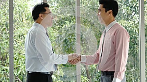 Team Business Partners shaking hands together to Greeting Start up small business in meeting room. Shakehand teamwork partners at photo