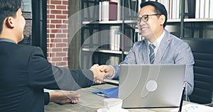 Team Business Partners shaking hands together to Greeting Start up small business in meeting room. Shakehand teamwork partners at photo