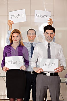 Team of business people holding card boards