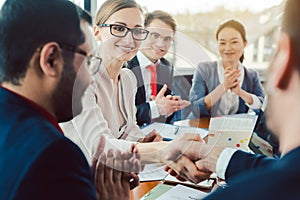 Team of business people negotiating an agreement closing the deal