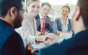 Team of business people negotiating an agreement closing the deal