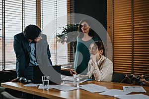 Team of business professionals reviewing documents in a modern office setting