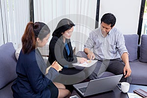 Team of business three people working together on a laptop with