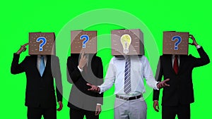 Team of businessman hiding head with box and gesturing