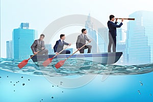 The team of businessmen in teamwork concept with boat