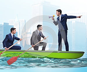 The team of businessmen in teamwork concept with boat