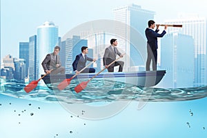 The team of businessmen in teamwork concept with boat