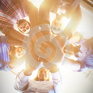 Team of businesspeople forming handstack